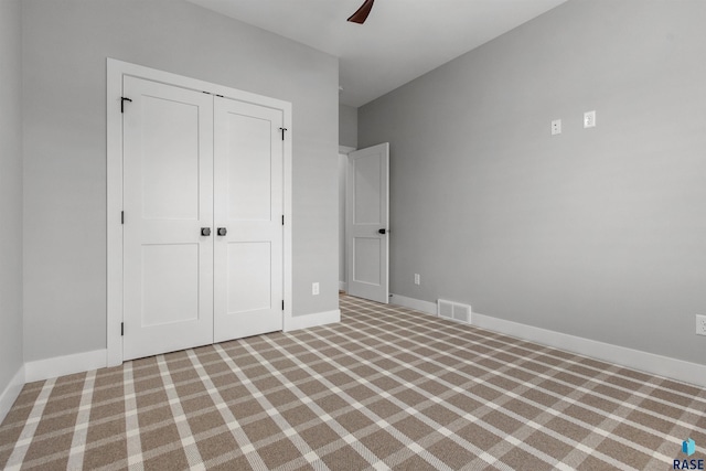 7324 E Twin Pines Ct, Sioux Falls, SD 57110 - unfurnished bedroom with carpet flooring, a closet, baseboards, and ceiling fan