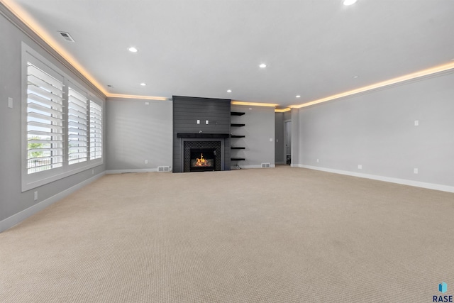 7324 E Twin Pines Ct, Sioux Falls, SD 57110 - unfurnished living room with baseboards, crown molding, light carpet, a large fireplace, and recessed lighting