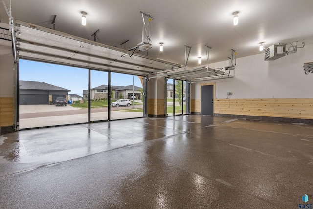 7324 E Twin Pines Ct, Sioux Falls, SD 57110 - garage with a garage door opener, a heating unit, and wood walls