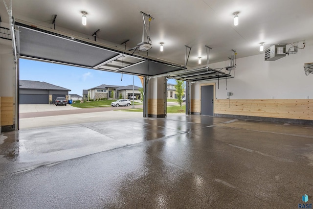 7324 E Twin Pines Ct, Sioux Falls, SD 57110 - garage with a garage door opener, a heating unit, wainscoting, and wood walls