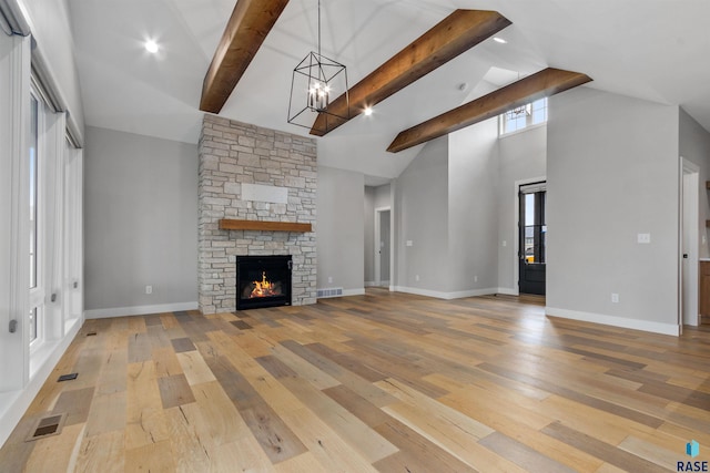 7324 E Twin Pines Ct, Sioux Falls, SD 57110 - unfurnished living room with high vaulted ceiling, a chandelier, light wood-type flooring, beam ceiling, and baseboards