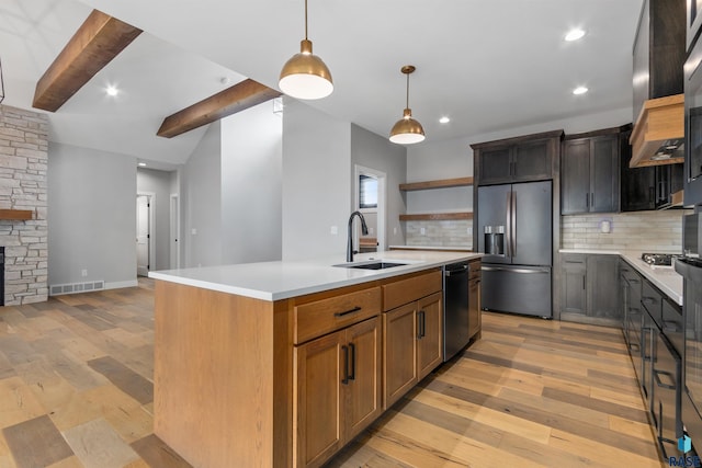 7324 E Twin Pines Ct, Sioux Falls, SD 57110 - kitchen with appliances with stainless steel finishes, a sink, tasteful backsplash, open shelves, and light wood-style floors