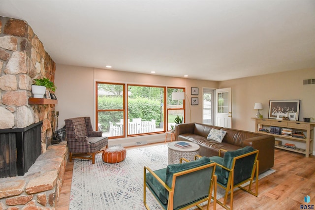 2804 S 1st Ave, Sioux Falls, SD 57105 - living room with wood finished floors, healthy amount of natural light, a stone fireplace, and recessed lighting