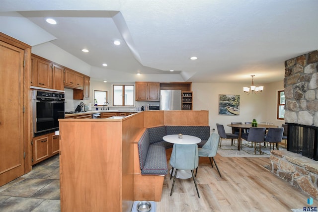 2804 S 1st Ave, Sioux Falls, SD 57105 - kitchen featuring stainless steel appliances, a chandelier, plenty of natural light, recessed lighting, and brown cabinets