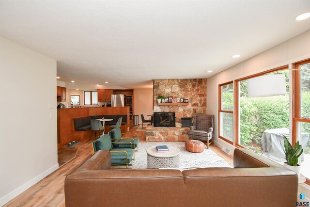 2804 S 1st Ave, Sioux Falls, SD 57105 - living area with light wood finished floors, plenty of natural light, a stone fireplace, recessed lighting, and baseboards