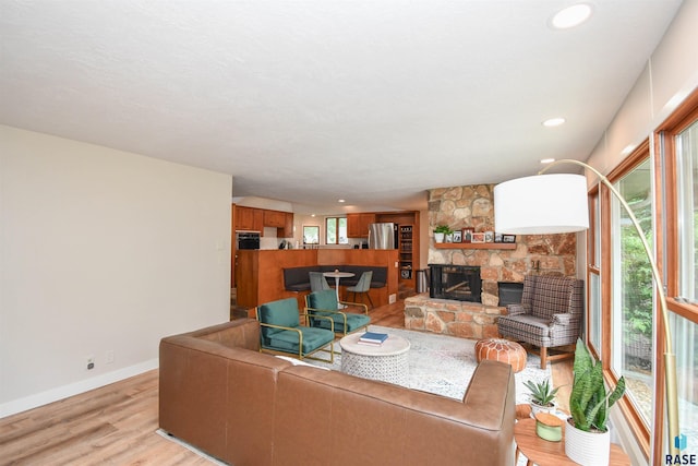 2804 S 1st Ave, Sioux Falls, SD 57105 - living room featuring light wood finished floors, a fireplace, baseboards, and recessed lighting