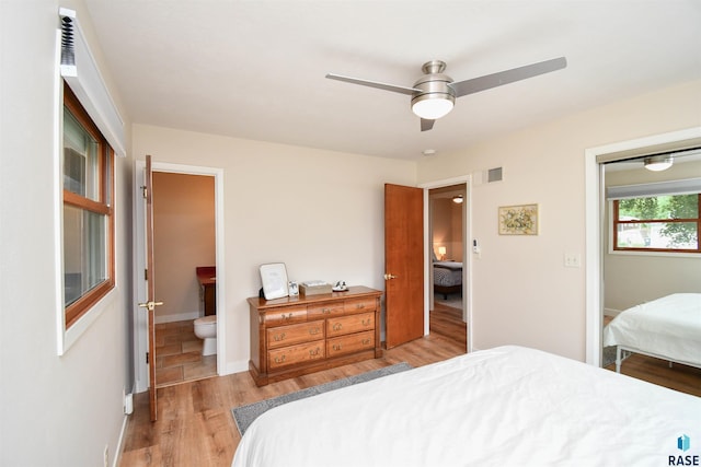 2804 S 1st Ave, Sioux Falls, SD 57105 - bedroom with wood finished floors, a ceiling fan, ensuite bath, and baseboards