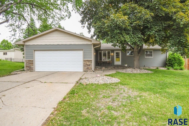 2804 S 1st Ave, Sioux Falls, SD 57105 - ranch-style home with stone siding, an attached garage, and driveway