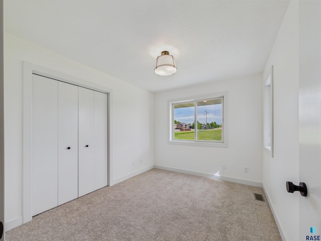 2506 E Augusta St, Brandon, SD 57005 - unfurnished bedroom with carpet flooring, a closet, and baseboards