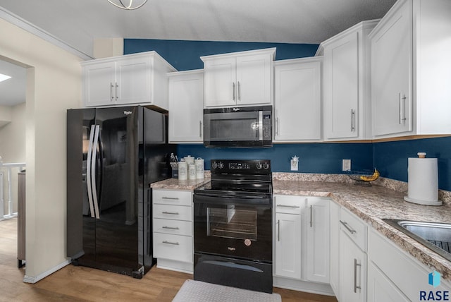 1304 N Tahoe Trl, Sioux Falls, SD 57110 - kitchen featuring black appliances, white cabinets, light wood-type flooring, light countertops, and vaulted ceiling