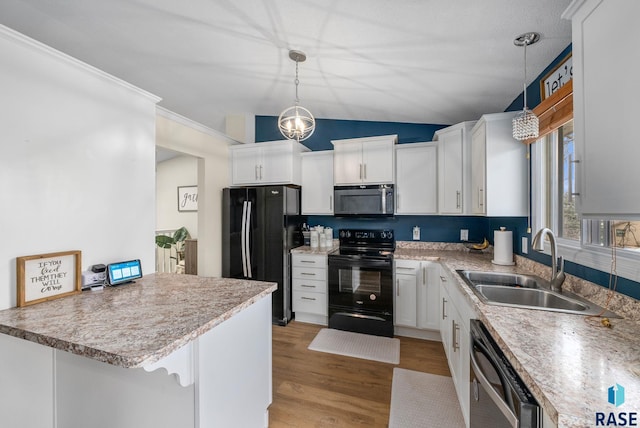 1304 N Tahoe Trl, Sioux Falls, SD 57110 - kitchen featuring black appliances, a sink, white cabinets, light wood finished floors, and lofted ceiling