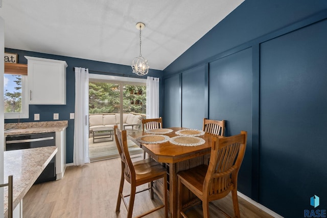 1304 N Tahoe Trl, Sioux Falls, SD 57110 - dining room featuring a chandelier, vaulted ceiling, light wood-style floors, and baseboards