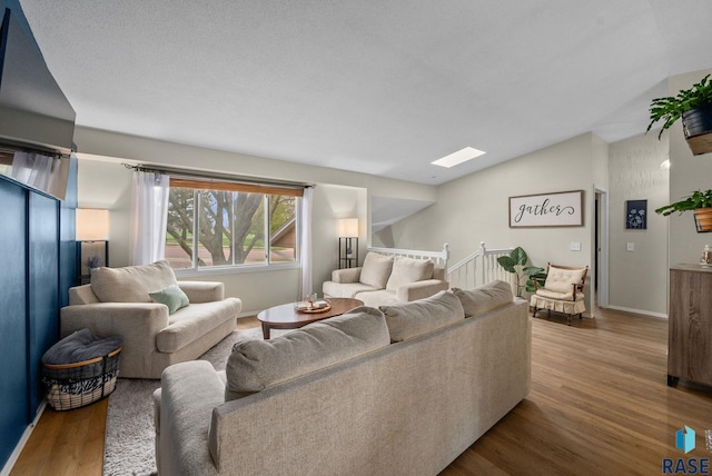 1304 N Tahoe Trl, Sioux Falls, SD 57110 - living area featuring wood finished floors, vaulted ceiling, and baseboards