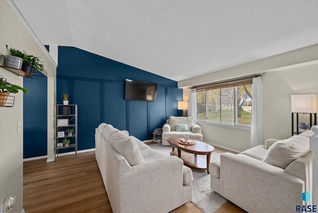 1304 N Tahoe Trl, Sioux Falls, SD 57110 - living area featuring wood finished floors, vaulted ceiling, and baseboards