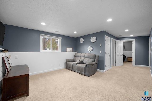 1304 N Tahoe Trl, Sioux Falls, SD 57110 - living room with recessed lighting, light colored carpet, baseboards, and a textured ceiling