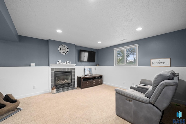 1304 N Tahoe Trl, Sioux Falls, SD 57110 - living area featuring recessed lighting, carpet, a tile fireplace, baseboards, and a textured ceiling