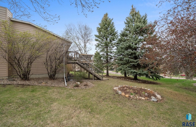 1304 N Tahoe Trl, Sioux Falls, SD 57110 - view of green lawn with stairway and a wooden deck