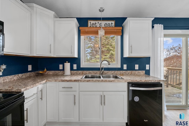 1304 N Tahoe Trl, Sioux Falls, SD 57110 - kitchen with black appliances, a sink, white cabinets, decorative light fixtures, and light wood-style floors