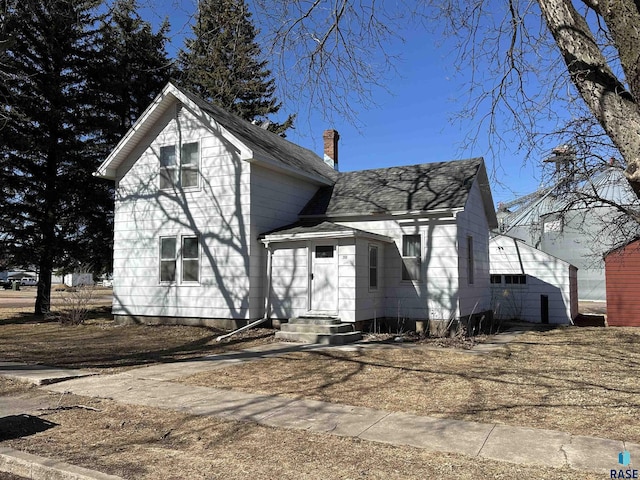 200 E 2nd St, Freeman, SD 57029 - traditional home with a chimney and roof with shingles