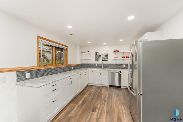 4315 S Cathedral Ave, Sioux Falls, SD 57103 - kitchen with stainless steel appliances, open shelves, light wood-style flooring, white cabinetry, and light stone countertops