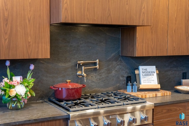 151 E 4th Pl Unit 102, Sioux Falls, SD 57104 - kitchen view of pot filler, backsplash, modern cabinets, and brown cabinetry