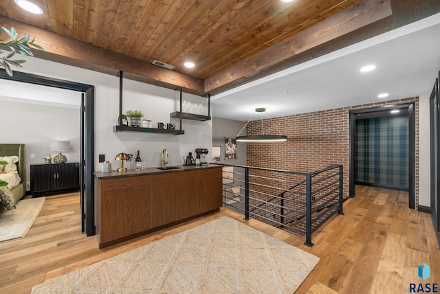 151 E 4th Pl Unit 102, Sioux Falls, SD 57104 - indoor wet bar featuring light wood-style flooring, wooden ceiling, and brick wall