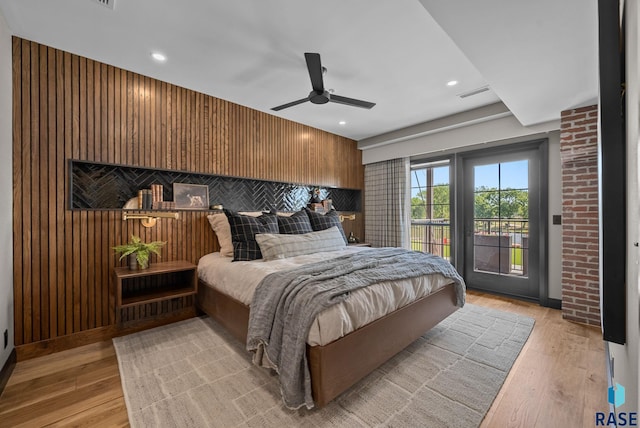 151 E 4th Pl Unit 102, Sioux Falls, SD 57104 - bedroom with access to exterior, light wood-style floors, wood walls, a ceiling fan, and recessed lighting