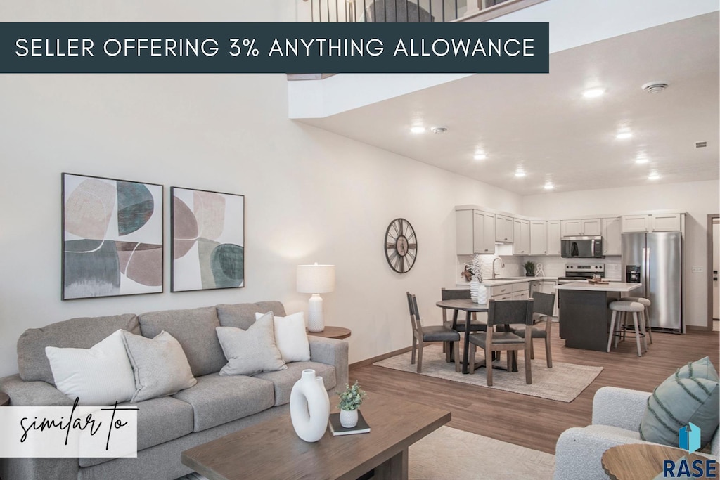 5717 E Avett Pl, Sioux Falls, SD 57108 - living room featuring light wood-style floors and baseboards