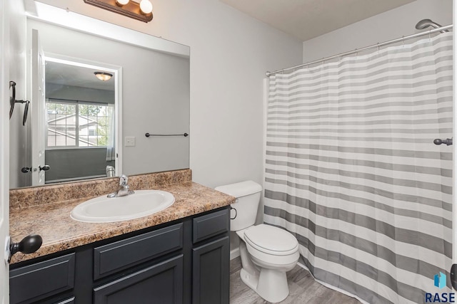 6501 S Santa Rosa Pl, Sioux Falls, SD 57108 - bathroom featuring vanity, toilet, wood finished floors, and curtained shower