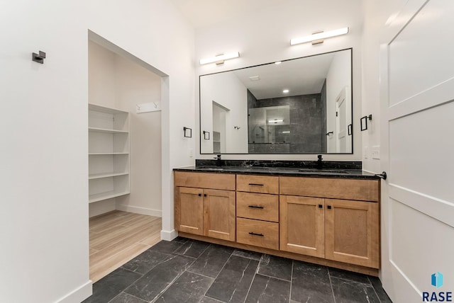 413 W 5th St, Crooks, SD 57020 - bathroom featuring double vanity, a stall shower, baseboards, and marble finish floors