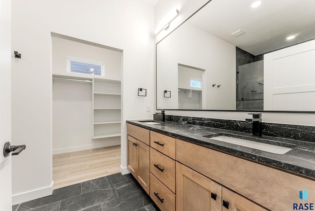 413 W 5th St, Crooks, SD 57020 - full bathroom featuring double vanity, baseboards, a tile shower, a spacious closet, and recessed lighting