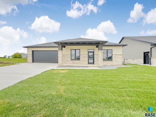 413 W 5th St, Crooks, SD 57020 - prairie-style house featuring stone siding, driveway, a front yard, a garage, and stucco siding