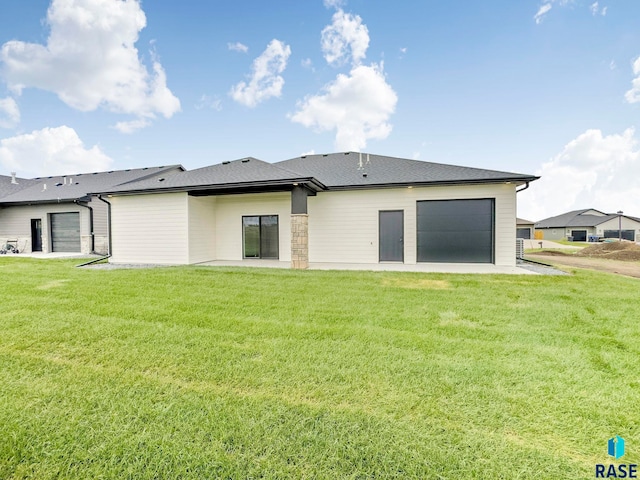 413 W 5th St, Crooks, SD 57020 - rear view of property with a yard and an attached garage