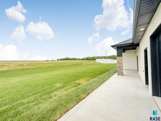 413 W 5th St, Crooks, SD 57020 - view of grassy yard with a view of countryside and a patio