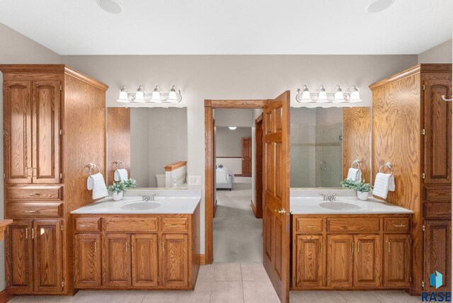 417 E Meadowlark Cir, Brandon, SD 57005 - full bath with two vanities, a stall shower, tile patterned floors, and toilet