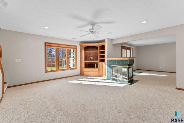 417 E Meadowlark Cir, Brandon, SD 57005 - unfurnished living room with baseboards, a tiled fireplace, carpet flooring, recessed lighting, and ceiling fan
