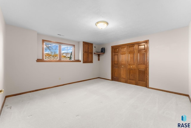 417 E Meadowlark Cir, Brandon, SD 57005 - unfurnished bedroom with a closet, baseboards, and light carpet