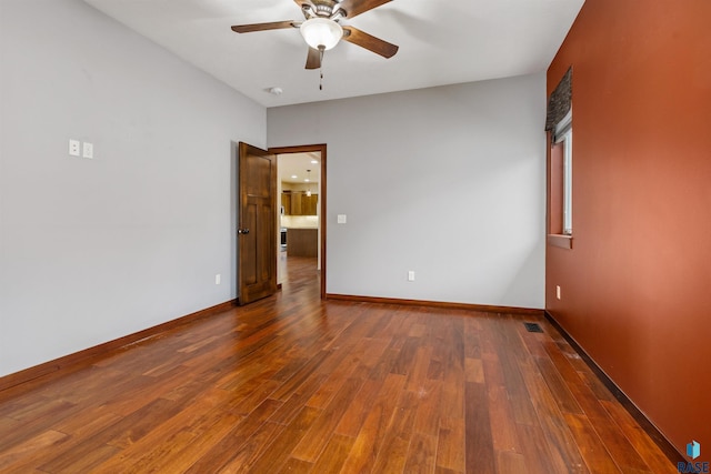301 S Spring Pl, Brandon, SD 57005 - spare room featuring a ceiling fan, wood finished floors, and baseboards