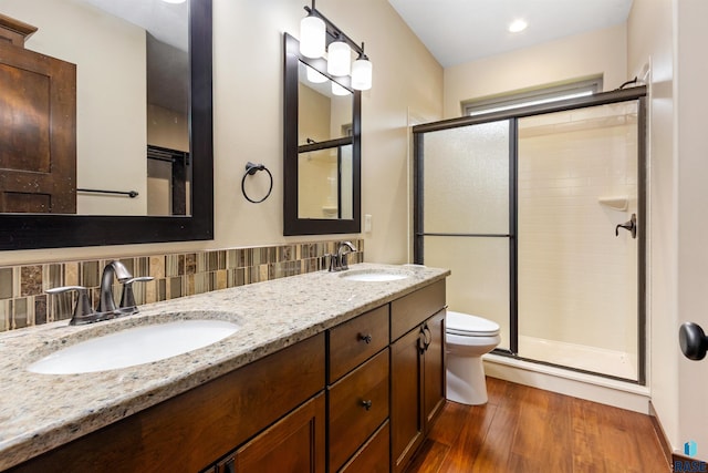 301 S Spring Pl, Brandon, SD 57005 - bathroom with toilet, a stall shower, wood finished floors, and double vanity