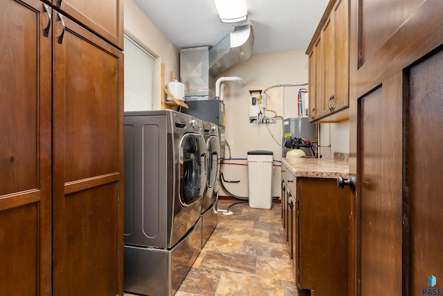 301 S Spring Pl, Brandon, SD 57005 - laundry area with independent washer and dryer, cabinet space, stone finish floors, and water heater