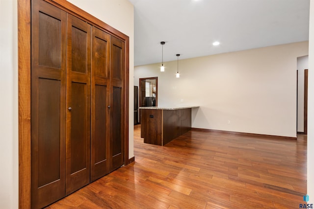301 S Spring Pl, Brandon, SD 57005 - kitchen featuring wood finished floors, a peninsula, hanging light fixtures, baseboards, and recessed lighting
