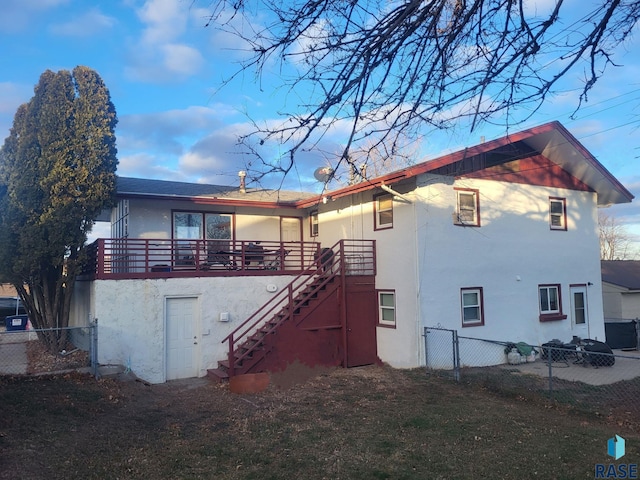 3605 E 18th St, Sioux Falls, SD 57103 - rear view of house with stucco siding and stairway