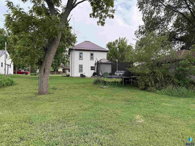 208 E Washington St, Marion, SD 57043 - view of grassy yard with a trampoline