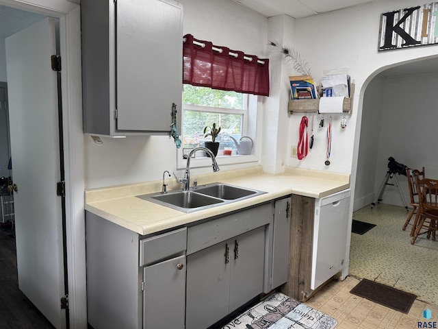 208 E Washington St, Marion, SD 57043 - kitchen featuring gray cabinets, a sink, light flooring, dishwasher, and light countertops
