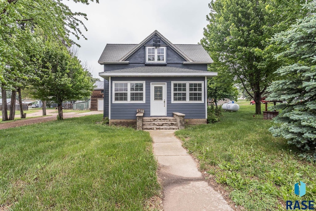 136 E Main St, Irene, SD 57037 - view of front of house featuring a front yard and a shingled roof