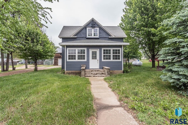 136 E Main St, Irene, SD 57037 - view of front of house featuring a front yard and a shingled roof