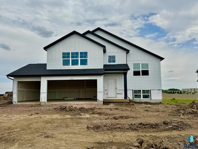 2900 S Copper Creek Ave, Sioux Falls, SD 57110 - view of front of home featuring board and batten siding, an attached garage, driveway, and a shingled roof