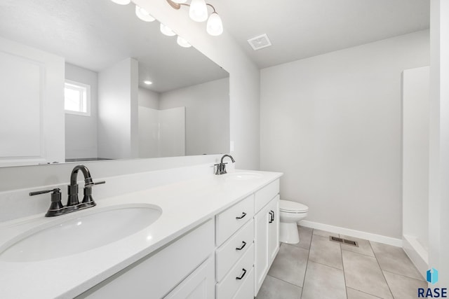 2900 S Copper Creek Ave, Sioux Falls, SD 57110 - full bathroom with double vanity, toilet, baseboards, tile patterned floors, and a shower