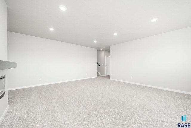2900 S Copper Creek Ave, Sioux Falls, SD 57110 - unfurnished living room with recessed lighting, light colored carpet, baseboards, and stairway