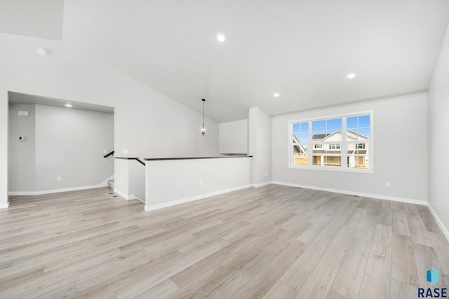 2900 S Copper Creek Ave, Sioux Falls, SD 57110 - unfurnished living room with light wood-style flooring, lofted ceiling, baseboards, and recessed lighting
